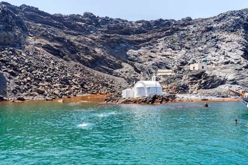 The white village of Oia perched on the cliffs of the Santorini Caldera.